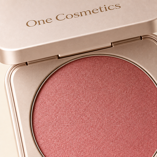 Illustrative close-up of open One Cosmetics blush compact and powder texture